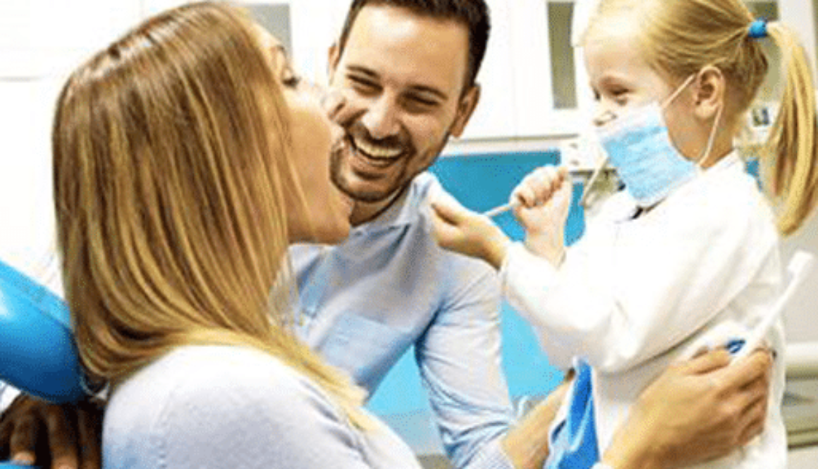 Couple laughing with their kid at dental office