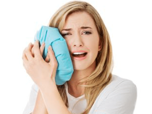 Woman in Tooth pain applying ice pack