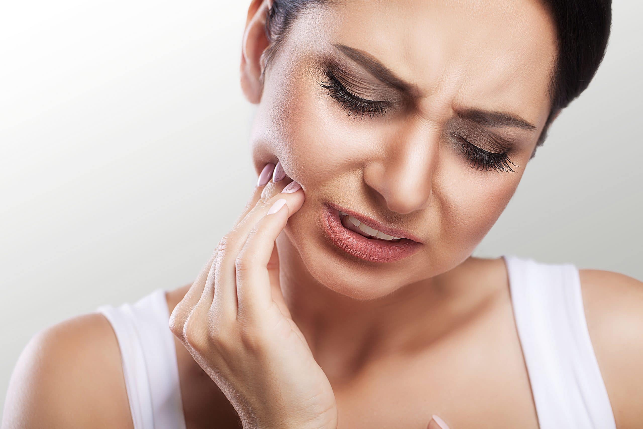 woman feeling tooth pain